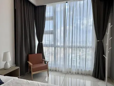 a bedroom with a chair and a large window at Balcony Cityscape IIII The Robertson Residence 42f in Kuala Lumpur