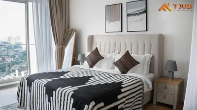a bedroom with a black and white bed with a window at Quill Suite 1R1B Netflix HD1080 with Infinity Pool in Kuala Lumpur