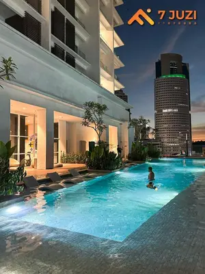 a man in a swimming pool in a building at Quill Suite 1R1B Netflix HD1080 with Infinity Pool in Kuala Lumpur