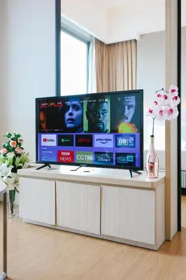 a large flat screen tv sitting on top of a table at Swiss Garden Residence by Aspire Suites in Kuala Lumpur