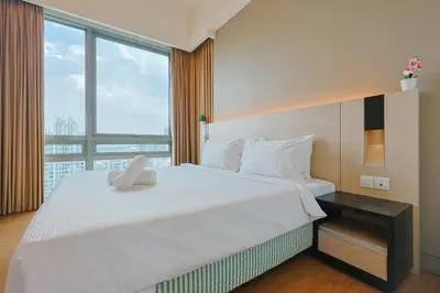 a bedroom with a large bed with a large window at Swiss Garden Residence by Aspire Suites in Kuala Lumpur
