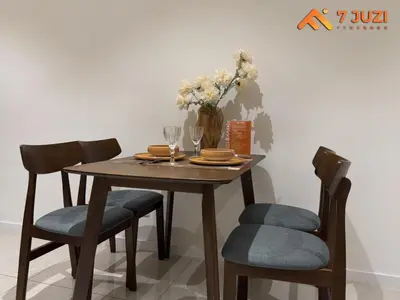 a wooden table with chairs and a vase with flowers at Quill Residence 1R1B with Netflix 23F&Massive Pool in Kuala Lumpur