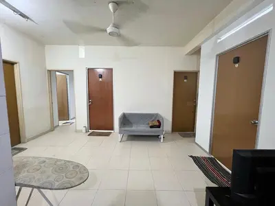 a hallway with a room with a chair and doors at Male Room at Plaza Rah, KL City Centre in Kuala Lumpur