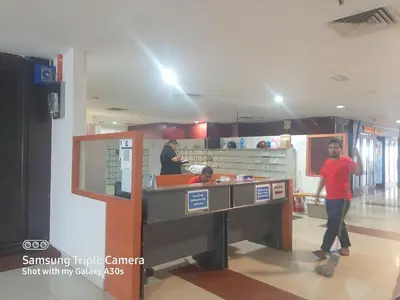 a man standing at a counter in a kitchen at Male Room at Plaza Rah, KL City Centre in Kuala Lumpur