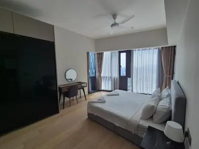 a bedroom with a bed and a desk and a window at Star Residence Sky World KLCC in Kuala Lumpur