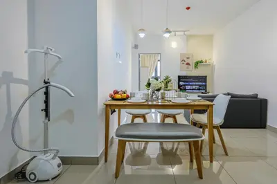 a kitchen and dining room with a table and chairs at Stylish M Vertica 4 Bedroom Walk to MRT Velocity Mall in Kuala Lumpur