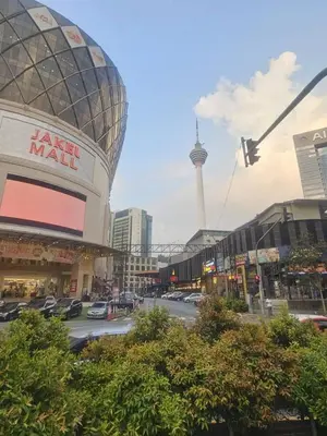 a city street with a large mall with cars parked at Maytower Apartment Studio Kuala Lumpur in Kuala Lumpur