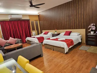 a hotel room with two beds and a couch at Maytower Apartment Studio Kuala Lumpur in Kuala Lumpur