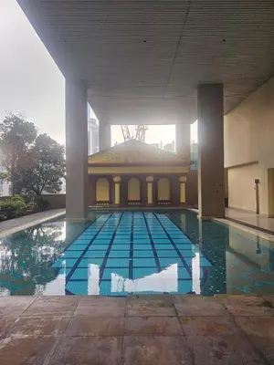 a large swimming pool with a building in the background at Maytower Apartment Studio Kuala Lumpur in Kuala Lumpur