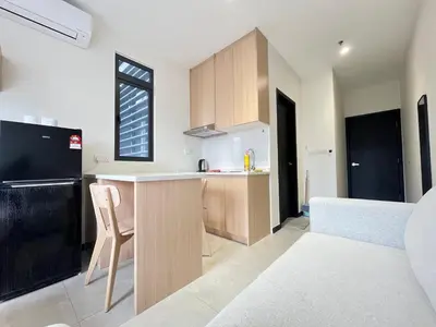 a kitchen with wooden cabinets and a counter top at Arte Plus Ampang By Comfortcorner in Kuala Lumpur