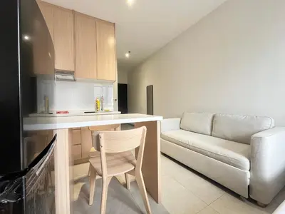 a kitchen with a couch and a table and a chair at Arte Plus Ampang By Comfortcorner in Kuala Lumpur