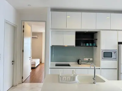 a kitchen with white cabinets and a sink at The Platinum KLCC By Homestay in Kuala Lumpur
