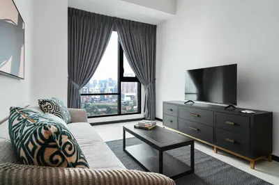 a living room with a couch and a tv at Opus by Soulasia in Kuala Lumpur