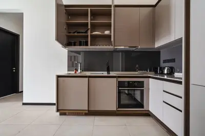 a kitchen with white cabinets and a stove at Opus by Soulasia in Kuala Lumpur