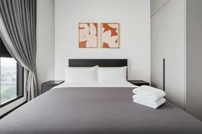 a bedroom with a large bed and a window at Opus by Soulasia in Kuala Lumpur