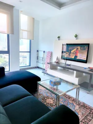 a living room with a black couch and a tv at Casa Residency apartment by Classy Homes in Kuala Lumpur