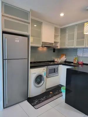 a kitchen with a refrigerator and a washing machine at Casa Residency apartment by Classy Homes in Kuala Lumpur