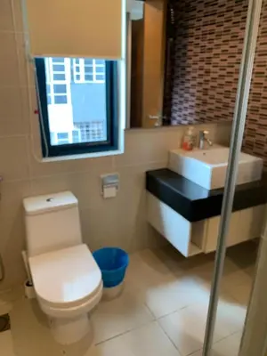 a bathroom with a white toilet and a sink at Casa Residency apartment by Classy Homes in Kuala Lumpur