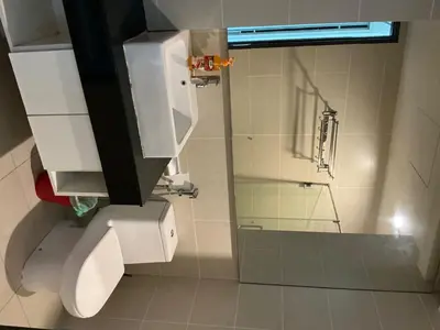 a bathroom with a toilet and a glass shower at Casa Residency apartment by Classy Homes in Kuala Lumpur