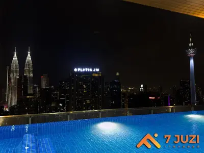 a swimming pool with a view of the city at night at KL &118 Tower View 1R1B Netflix 19F & Best View Infinity Pool in Kuala Lumpur