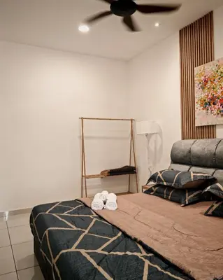 a bedroom with a bed with two towels on it at View KLCC 3 Bedroom Homestay Kenwingston Platz in Kuala Lumpur