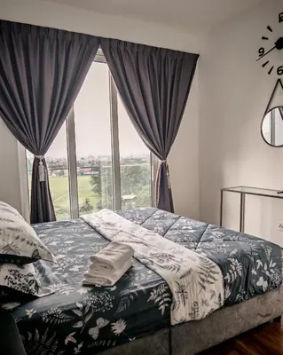 a bedroom with a bed and a window with curtains at Puncak Sentul KL with 3 Bedroom Homestay in Kuala Lumpur