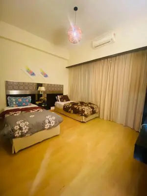a bedroom with two beds and a couch at Seri Bukit Ceylon Dreamy Destiny luxe Suites in Kuala Lumpur
