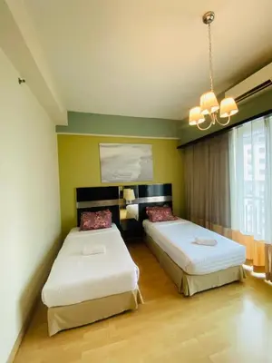 a bedroom with two beds and a chandelier at Seri Bukit Ceylon Dreamy Destiny luxe Suites in Kuala Lumpur