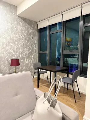 a living room with a couch and a table at Ceylonz Suites Bukit Bintang By ICEFLY in Kuala Lumpur