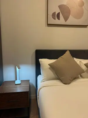 a bedroom with a bed and a nightstand with a lamp at Ceylonz Suites Bukit Bintang By ICEFLY in Kuala Lumpur