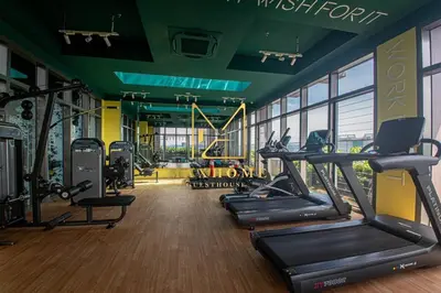 a gym with treadmills and ellipticals in a room at Maxhome Cozy at Riveria KL in Kuala Lumpur