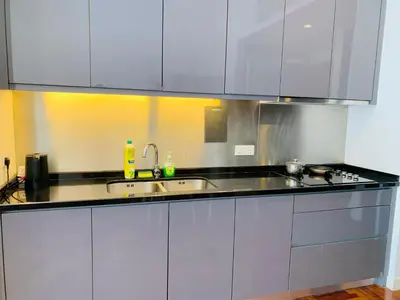 a kitchen with white cabinets and a sink at KLCC The Mews Luxury suites Malaysia in Kuala Lumpur