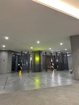 an empty lobby with a yellow sign on the wall at KLCC The Mews Luxury suites Malaysia in Kuala Lumpur