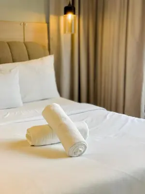 a towel on a bed in a hotel room at KLCC The Mews Luxury suites Malaysia in Kuala Lumpur