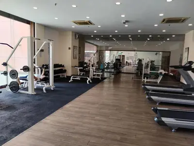 a gym with treadmills and machines in a room at SkS Service suite at times square in Kuala Lumpur