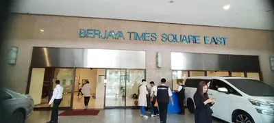 a group of people standing outside of a car dealership at SkS Service suite at times square in Kuala Lumpur