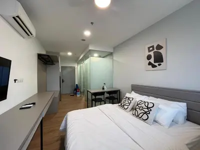 a bedroom with a bed and a desk in a room at City View Retreat in Kuala Lumpur