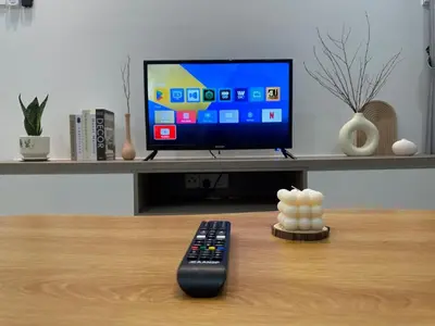 a remote control sitting on a table next to a television at KL City 3BR 3Bath Condo , Razak city ,TV box & Pool in Kuala Lumpur