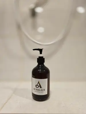 a black soap bottle sitting on a bathroom counter at Seko Suites by Aurelius Chow Kit in Kuala Lumpur