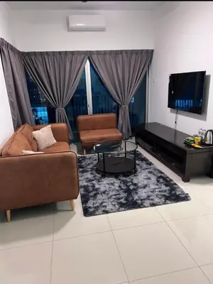a living room with a couch and a flat screen tv at Modern High-Floor 2BR Retreat 9km to KL City Centre in Kuala Lumpur