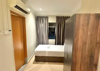 a small room with a bed and a window at Swing & Pillows - Bukit Bintang City Centre in Kuala Lumpur