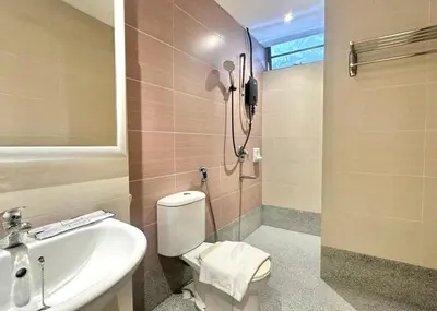 a bathroom with a toilet and a sink and a shower at Swing & Pillows - Bukit Bintang City Centre in Kuala Lumpur