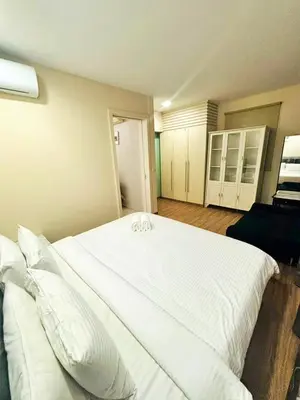 a large white bed with white pillows in a room at Bukit Bintang Fairlane suite by Rose in Kuala Lumpur