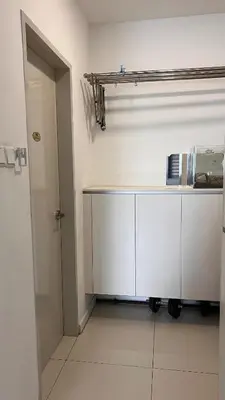 a white kitchen with a counter and a door at Cozy Chambers Studio KLCC Grand Opening Sale in Kuala Lumpur