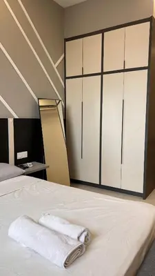 a bedroom with a bed with two towels on it at Cozy Chambers Studio KLCC Grand Opening Sale in Kuala Lumpur