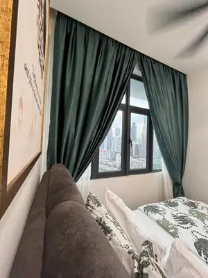 a bedroom with green curtains and a bed and a window at Legasi Kampong Baru By AMNA for Malay Only in Kuala Lumpur