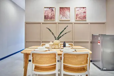 a table with chairs and a vase on it at Neu Suites Ampang near Gleneagles in Kuala Lumpur