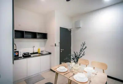 a kitchen with a table and chairs in a room at Neu Suites Ampang near Gleneagles in Kuala Lumpur