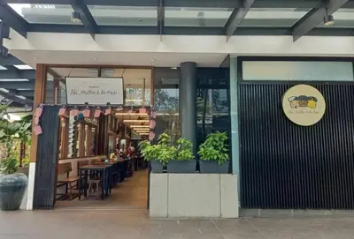 a store with potted plants in front of a building at Camellia Serviced Suites in Kuala Lumpur