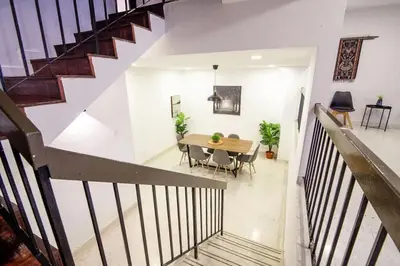 a staircase with a table and chairs in a house at Bukit Damansara Terrace in Kuala Lumpur